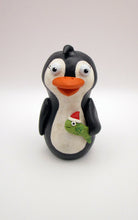 Christmas folk art penguin with a fish in hand