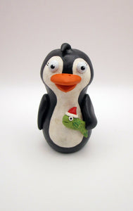 Christmas folk art penguin with a fish in hand