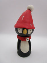 Christmas folk art penguin character with big red hat