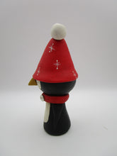 Christmas folk art penguin character with big red hat