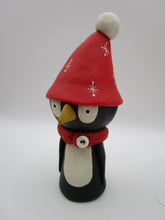 Christmas folk art penguin character with big red hat