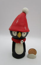 Christmas folk art penguin character with big red hat