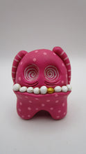 Pink Monster small with arms over her head and wacky teeth