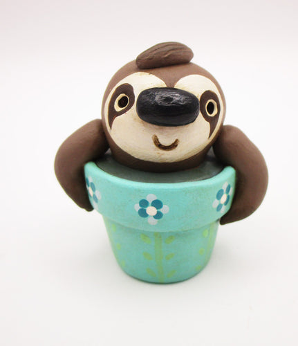 Spring folk art cute small sloth in a pot