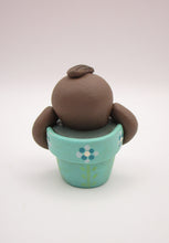 Spring folk art cute small sloth in a pot