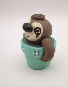 Spring folk art cute small sloth in a pot