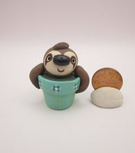 Spring folk art cute small sloth in a pot