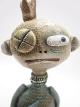 Primitive man with crown and lots of fine crackle and texture misc
