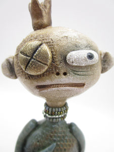 Primitive man with crown and lots of fine crackle and texture misc