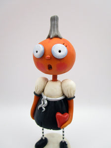 Halloween folk art pumpkin girl holding heart