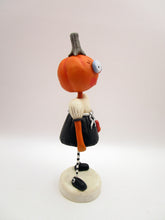 Halloween folk art pumpkin girl holding heart