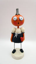 Halloween folk art pumpkin girl holding heart