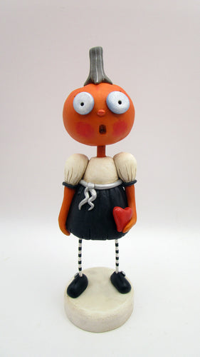 Halloween folk art pumpkin girl holding heart