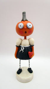 Halloween folk art pumpkin girl holding heart