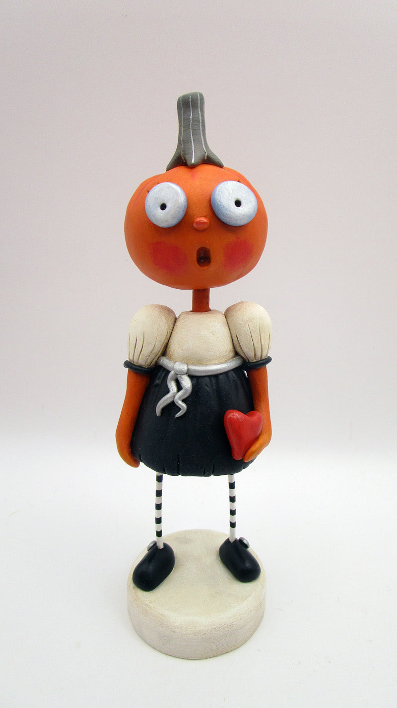 Halloween folk art pumpkin girl holding heart