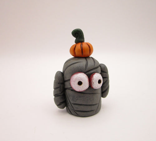 Halloween folk art small mummy man a tiny pumpkin on his head