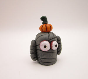 Halloween folk art small mummy man a tiny pumpkin on his head