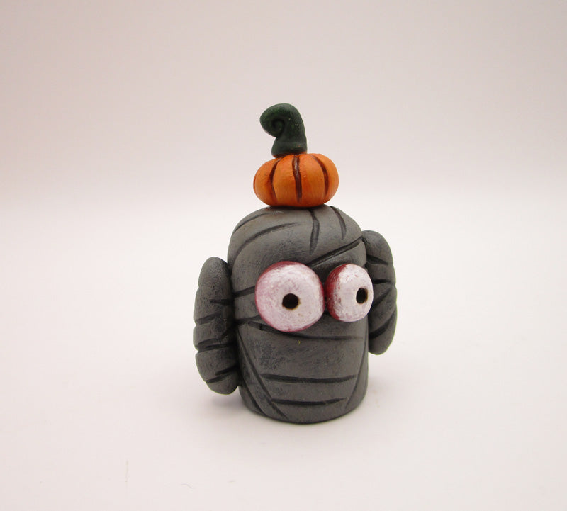 Halloween folk art small mummy man a tiny pumpkin on his head