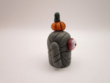 Halloween folk art small mummy man a tiny pumpkin on his head
