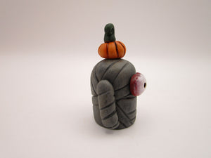 Halloween folk art small mummy man a tiny pumpkin on his head
