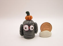 Halloween folk art small mummy man a tiny pumpkin on his head