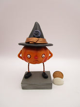Halloween folk art pumpkin character wearing black witch hat