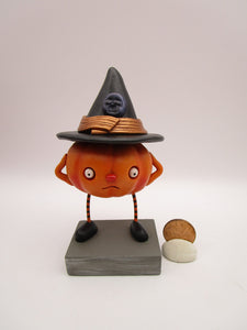 Halloween folk art pumpkin character wearing black witch hat