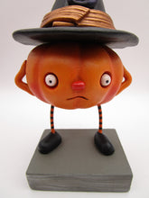 Halloween folk art pumpkin character wearing black witch hat