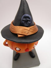Halloween folk art pumpkin character wearing black witch hat