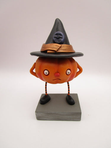 Halloween folk art pumpkin character wearing black witch hat