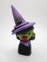 Halloween witch bust wearing purple with red lips