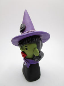 Halloween witch bust wearing purple with red lips