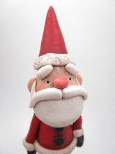 Traditional Christmas Santa Claus with detailed ornament in hand