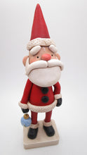 Traditional Christmas Santa Claus with detailed ornament in hand