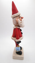 Traditional Christmas Santa Claus with detailed ornament in hand