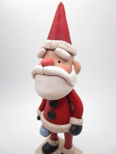 Traditional Christmas Santa Claus with detailed ornament in hand