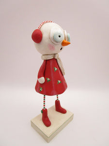 Christmas folk art snow girl with winter ear muffs and holly dress
