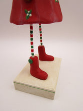 Christmas folk art snow girl with winter ear muffs and holly dress