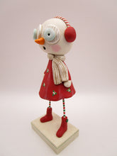 Christmas folk art snow girl with winter ear muffs and holly dress