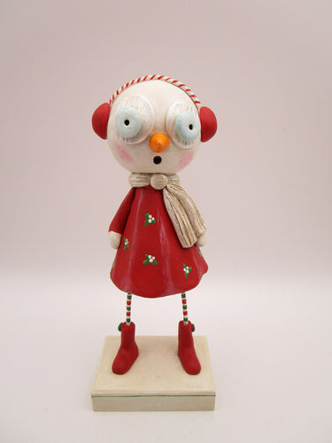 Christmas folk art snow girl with winter ear muffs and holly dress