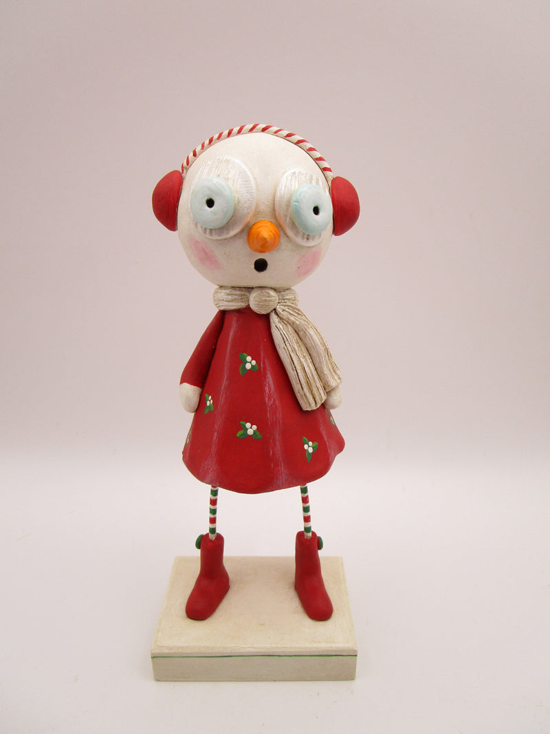 Christmas folk art snow girl with winter ear muffs and holly dress