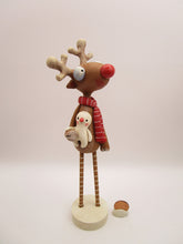Christmas folk art reindeer with wood legs holding snowman