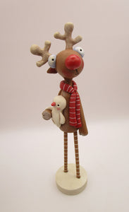 Christmas folk art reindeer with wood legs holding snowman