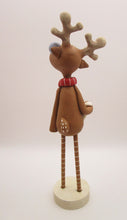 Christmas folk art reindeer with wood legs holding snowman