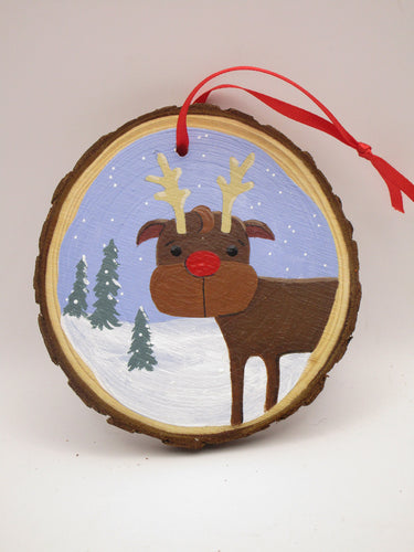 Christmas folk art ornament featuring reindeer on wood slice round