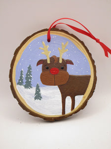 Christmas folk art ornament featuring reindeer on wood slice round