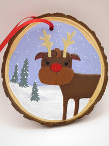 Christmas folk art ornament featuring reindeer on wood slice round