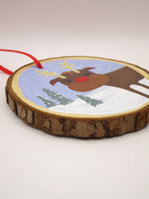 Christmas folk art ornament featuring reindeer on wood slice round
