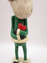 Christmas folk art Santa embracing a red heart