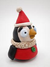 Christmas penguin wearing Santa style outfit